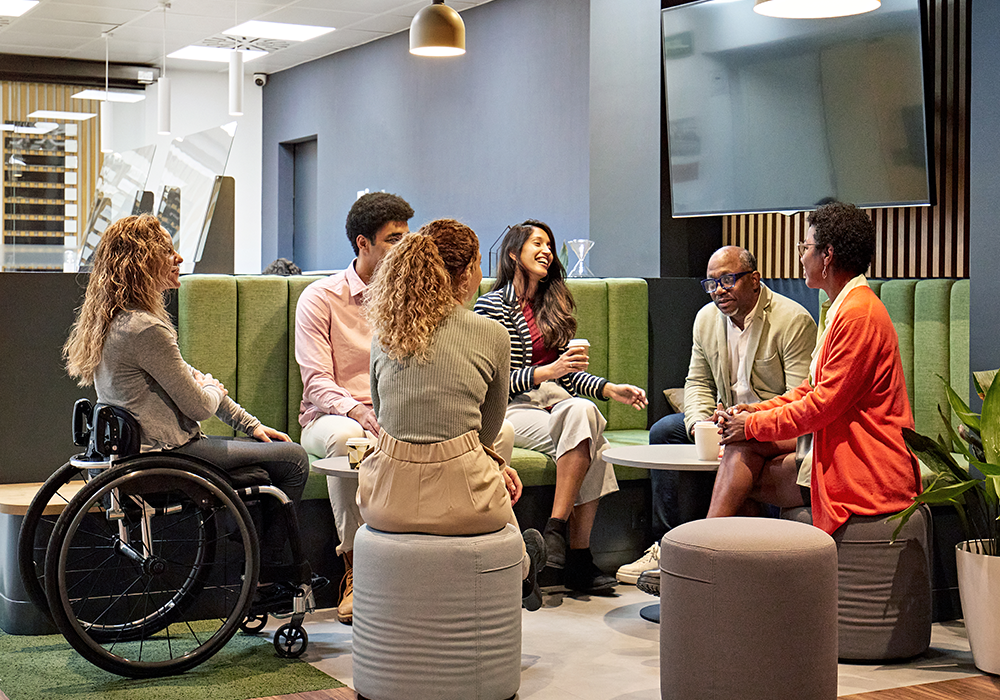 A diverse group siin discussion in a casual meeting area