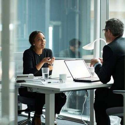Businesswoman speaking with co worker in open office