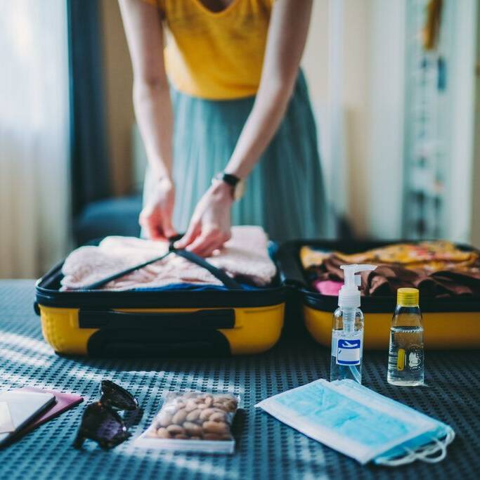 Suitcase packing for travel, COVID-19