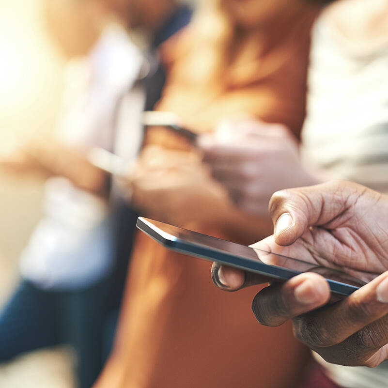 Shot of an unrecognizable  group of people social networking outside